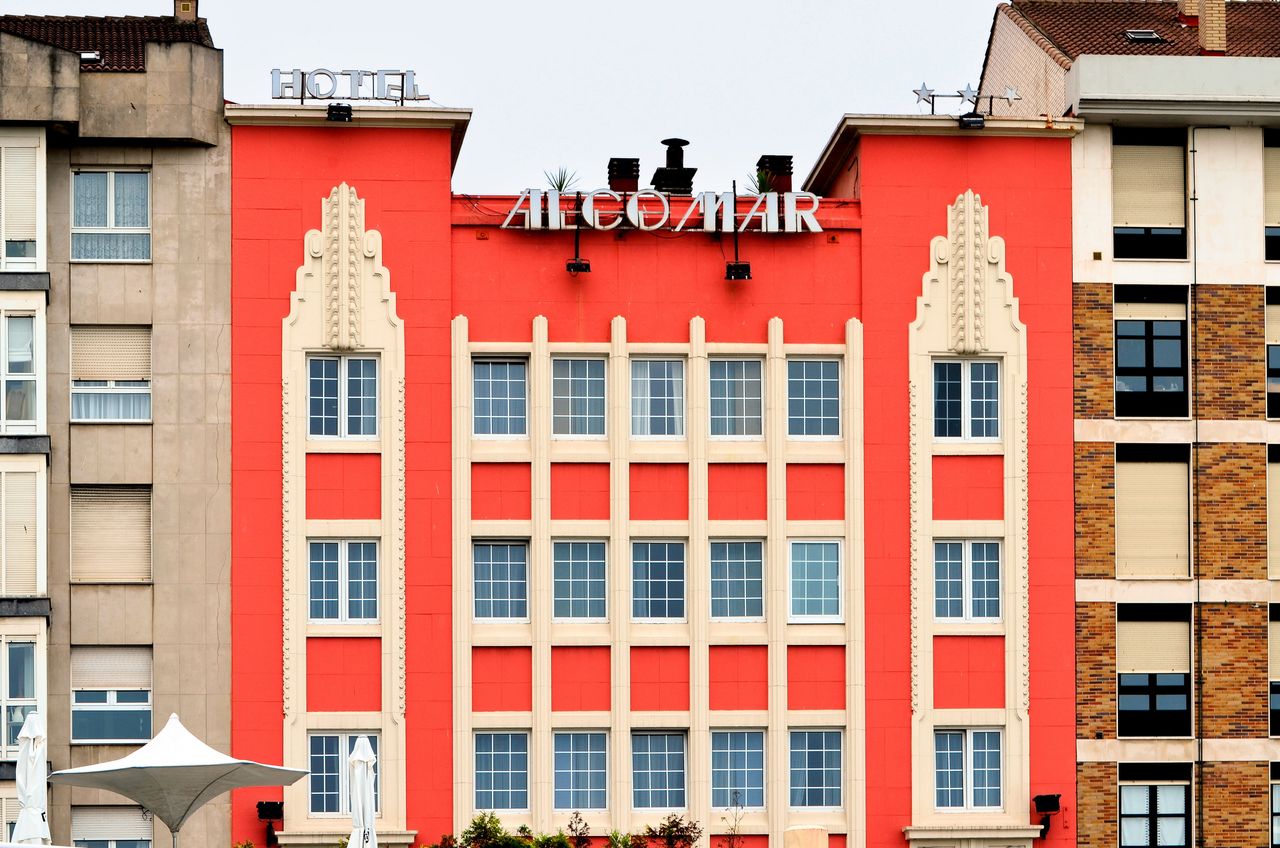 Art Deco facade of Hotel Alcomar in Gijón, showcasing vibrant architectural design.